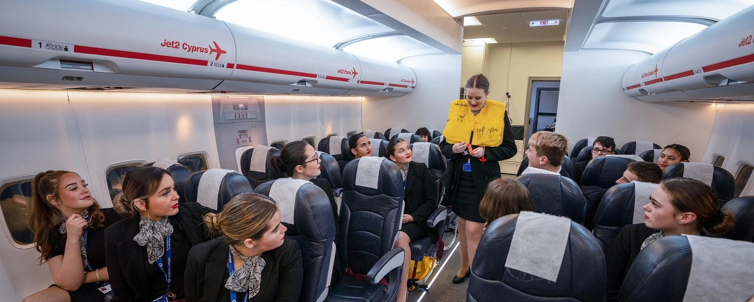Travel students in the aircraft cabin at the Maidstone Campus